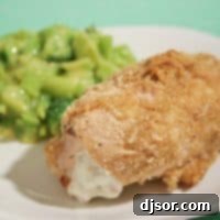 cheese stuffed chicken on a plate with broccoli