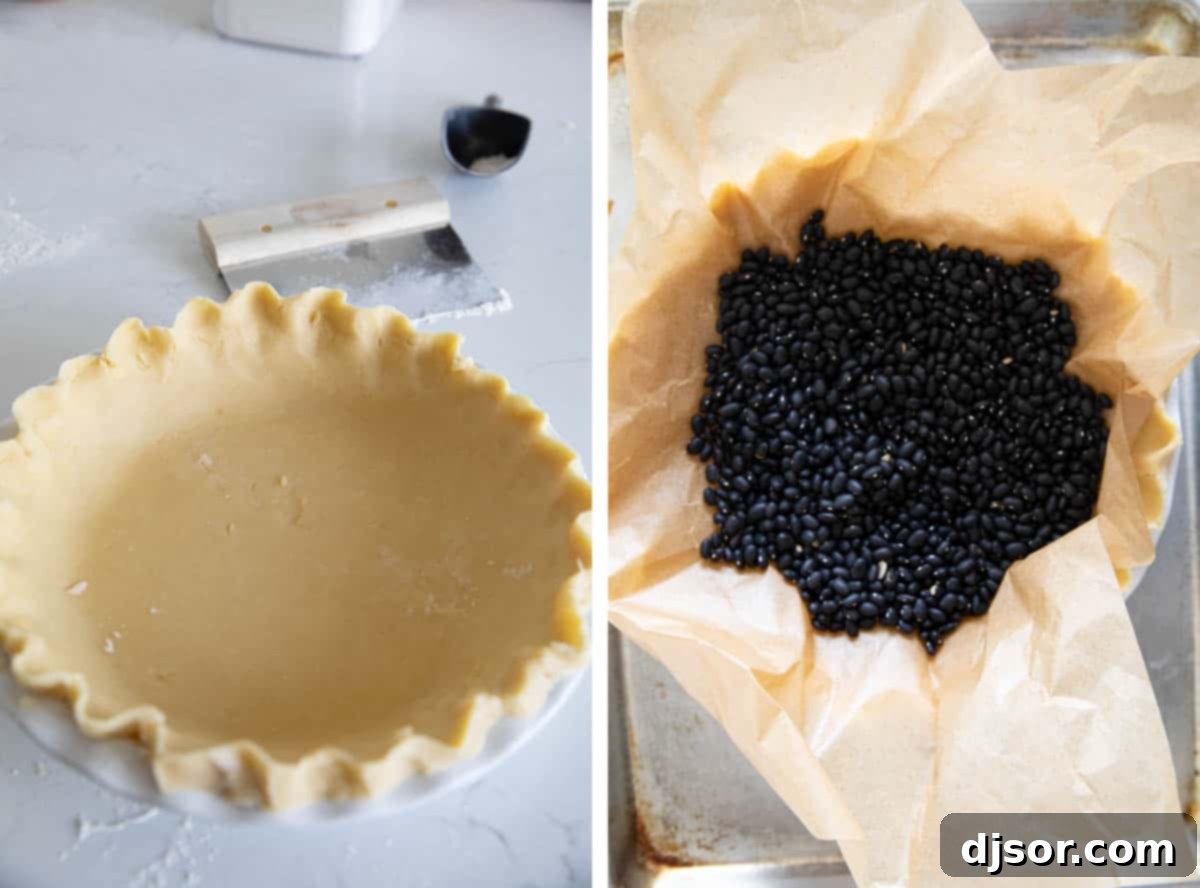 A pie crust being blind-baked in a pie plate, filled with pie weights to prevent shrinking.