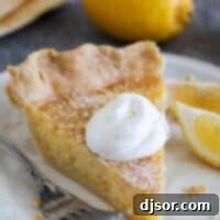 Slice of lemon chess pie topped with whipped cream.