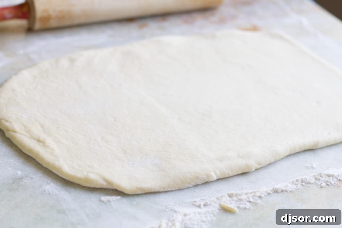 Dough rolled into an 11x14-inch rectangle on a lightly floured surface.