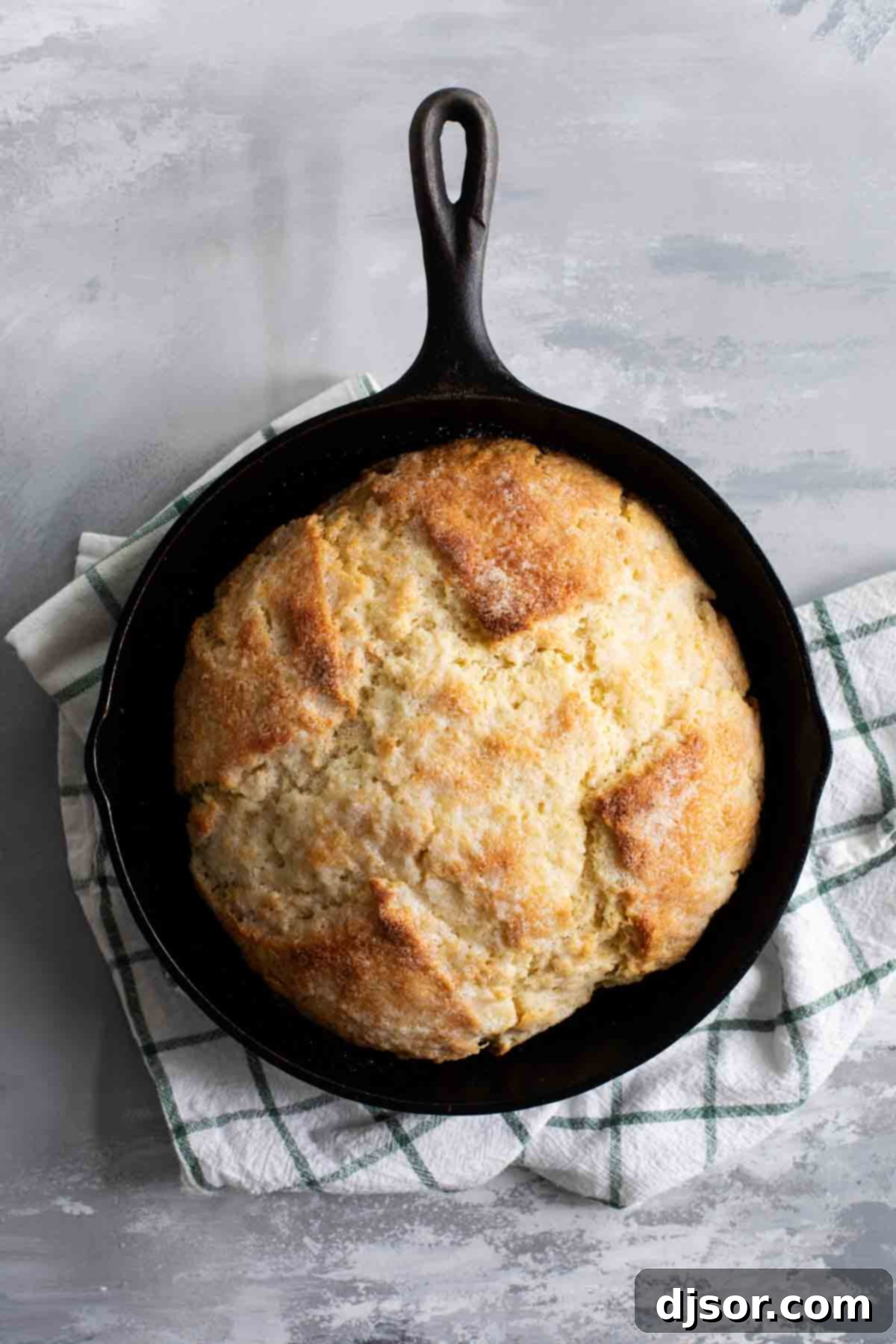 Ingredients for Irish Soda Bread laid out on a wooden surface, showing flour, butter, buttermilk, and other essentials.
