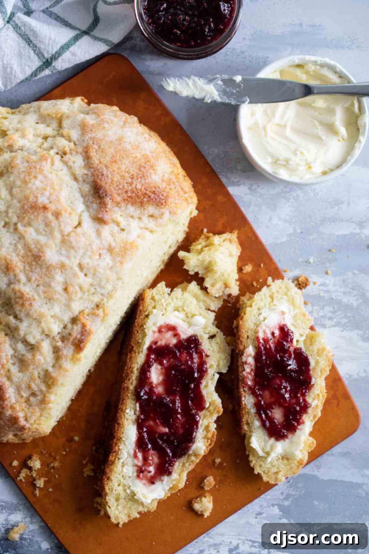 Close-up of several thick slices of warm Irish Soda Bread, showcasing its tender crumb and inviting texture.