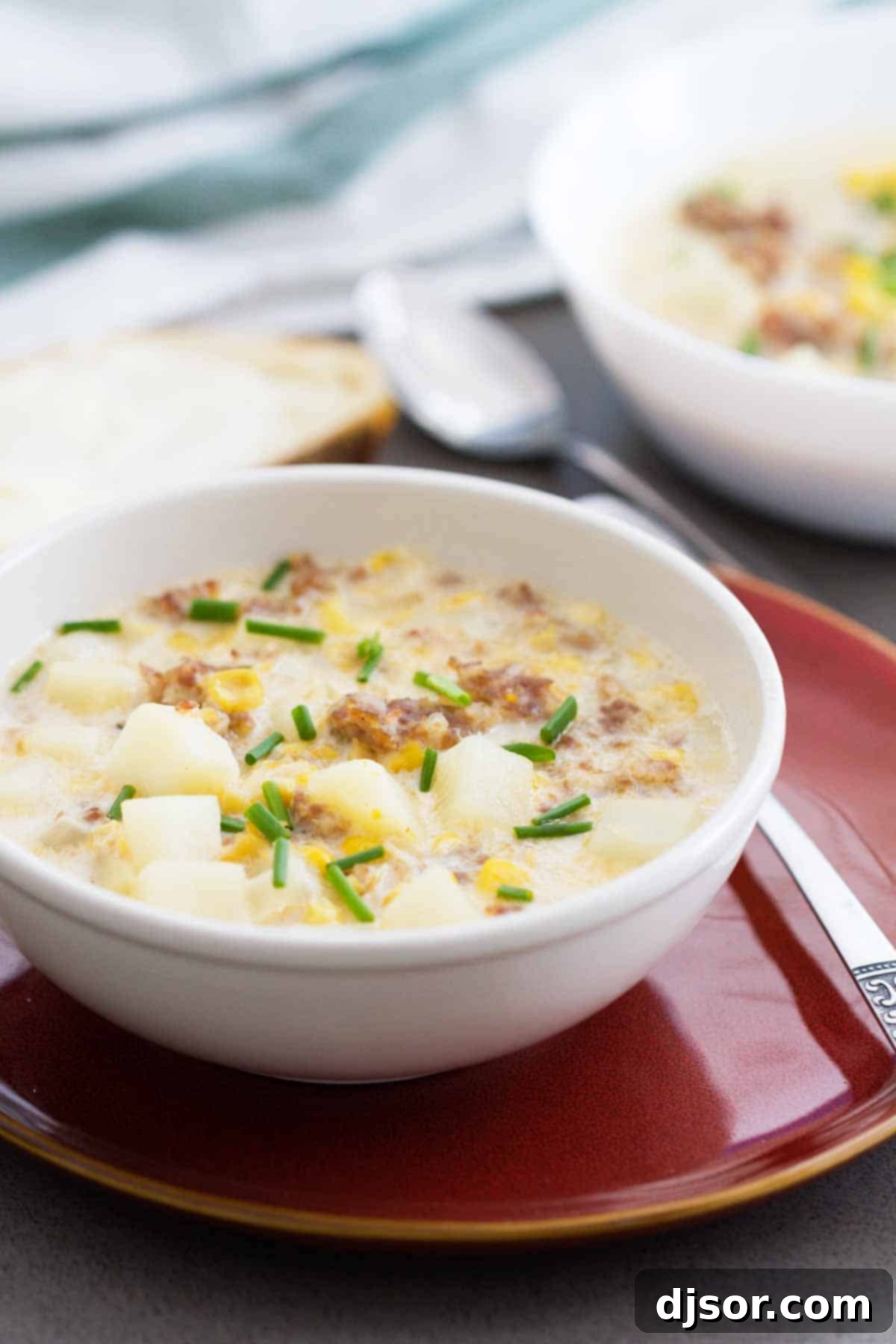 Easy Corn and Sausage Chowder - warm, comforting, filling and perfect for a cold day! This easy soup only takes a few ingredients and can be on the table in 40 minutes. A comforting bowl of Easy Corn and Sausage Chowder, garnished with fresh chives, perfect for a cold day.