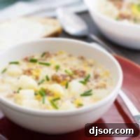 Hearty Corn and Sausage Chowder 2 A comforting bowl of Easy Corn and Sausage Chowder, garnished with fresh chives, ready to be served.