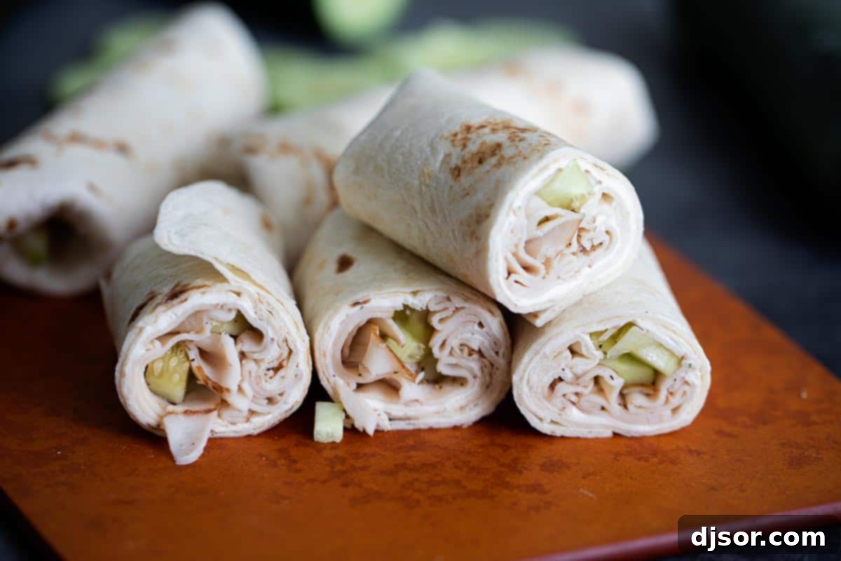 Freshly prepared Cucumber Ranch Turkey Tortilla Wraps, cut in half and attractively stacked, showcasing the vibrant ingredients inside.