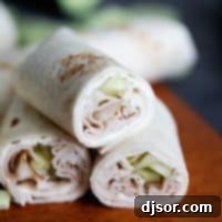 A close-up of a Cucumber Ranch Turkey Wrap, neatly cut in half and displayed to highlight its fresh ingredients and inviting texture.