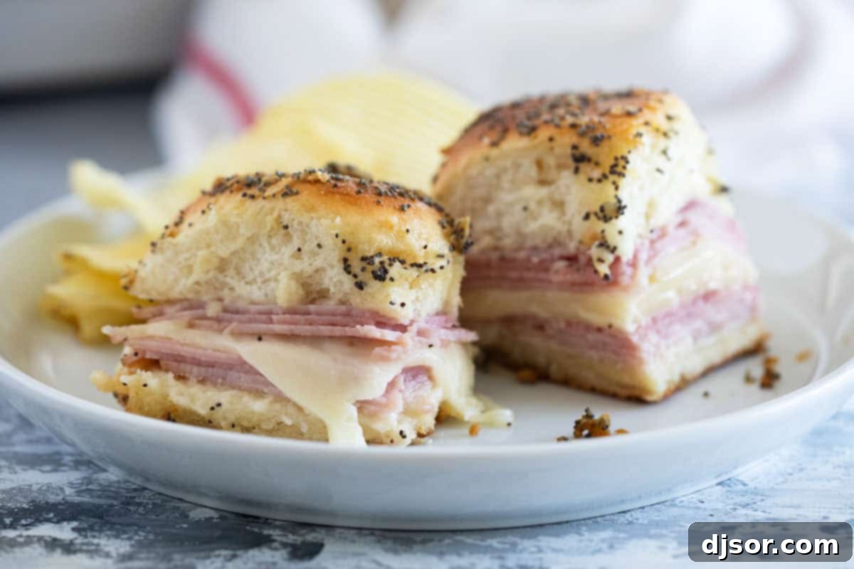 Ham and Cheese Sliders baked with poppy seeds, onions, and butter, golden brown and ready to serve.