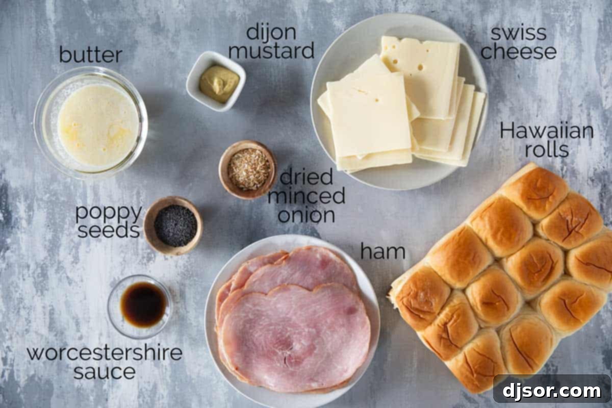 A top-down view of all the fresh ingredients laid out for making Ham and Cheese Sliders, including rolls, ham, cheese, and butter sauce components.