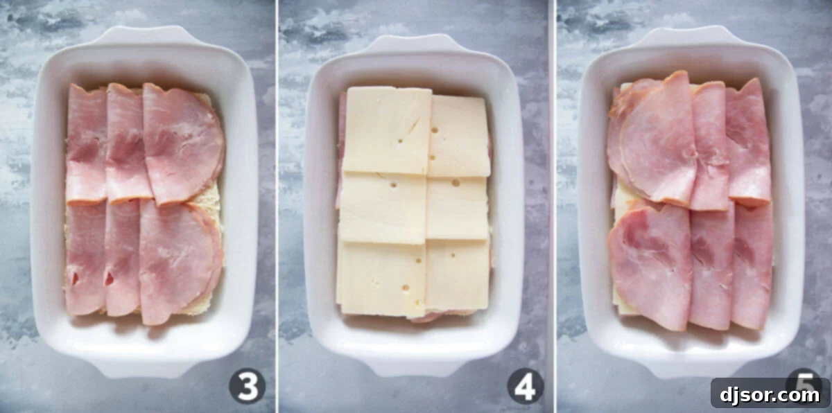 Detailed view of layering ham and cheese slices onto the bottom half of Hawaiian rolls in a baking dish, preparing for Ham and Cheese Sliders.