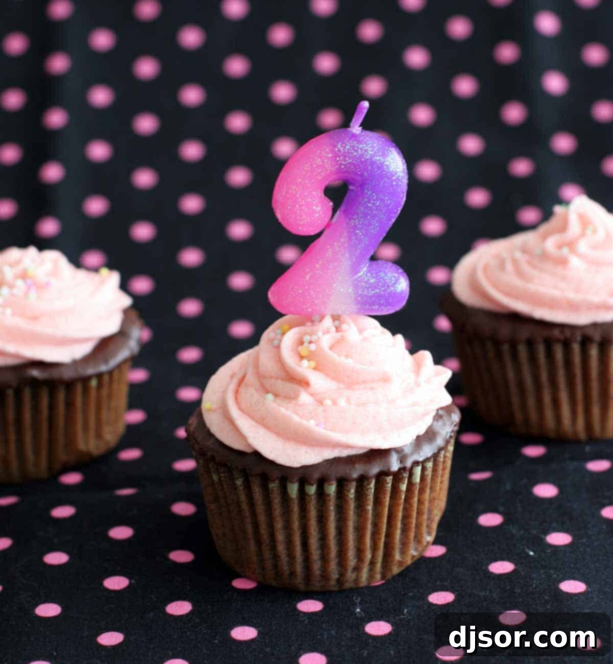 Chocolate cupcake with rich buttercream, a festive number 2 candle, and a sprinkle of celebration