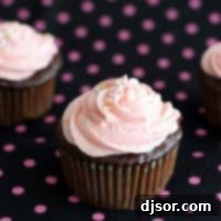 chocolate cupcakes topped with pink buttercream and sprinkles