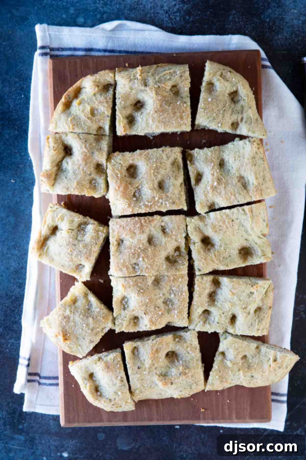 Perfectly baked focaccia bread, ready to serve overhead view of golden-brown focaccia bread sliced into perfect pieces