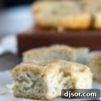 Artisan Focaccia From Scratch 2 piece of Focaccia Bread with a bite taken from it, showing golden crust