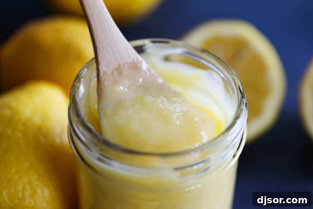 taking a spoonful of lemon curd with a spoon