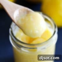 wooden spoon dipped in lemon curd