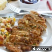 Piece of Potato Chip Chicken cut into slices on a plate.