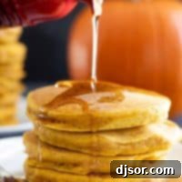 Pouring syrup on a stack of pumpkin pancakes