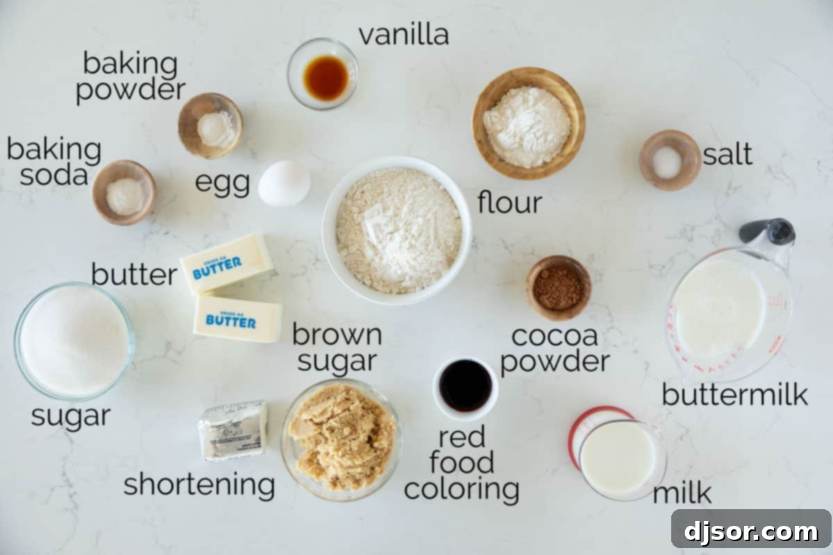 A selection of fresh ingredients laid out for making red velvet whoopie pies, including flour, cocoa powder, buttermilk, butter, and an egg.