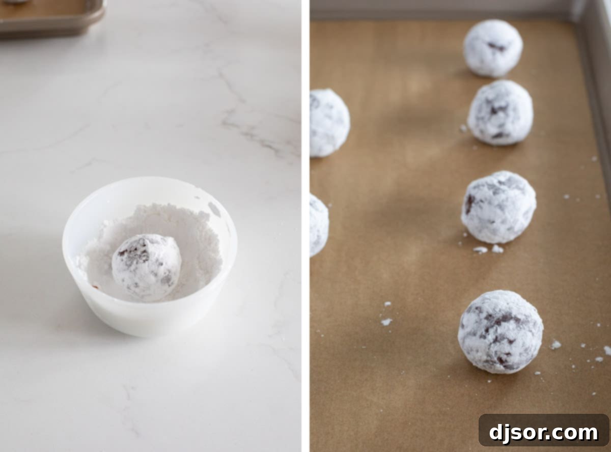 Hands rolling chocolate cookie dough balls in a bowl filled with white powdered sugar, preparing them for baking to create the crinkle effect.