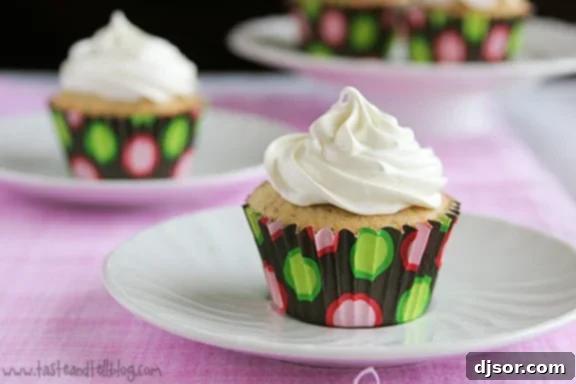 Delicious vanilla poppy seed cupcakes topped with fluffy lemon marshmallow frosting, perfect for spring celebrations.