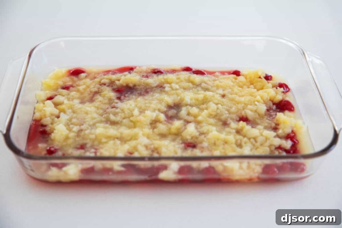 A blast from the past, this easy Dump Cake recipe only takes 4 ingredients. Switch up the filling ingredients depending on what you have on hand or what your favorite flavor is. A scoop of ice cream on top takes it to another level! crushed pineapple on top of cherry pie filling