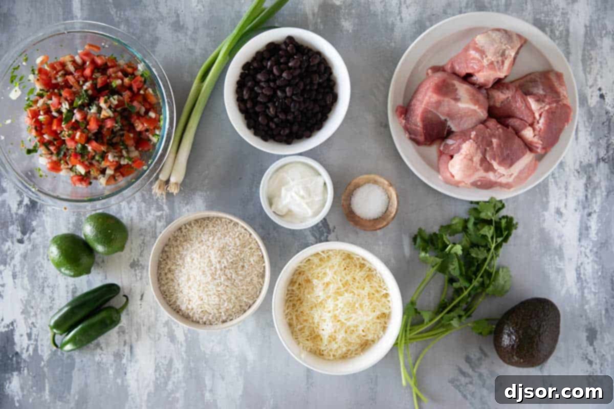 A flat lay photograph showcasing all the fresh and delicious ingredients laid out for preparing the Pork Carnitas Burrito Bowl, including vibrant vegetables, beans, rice, and the succulent pork.