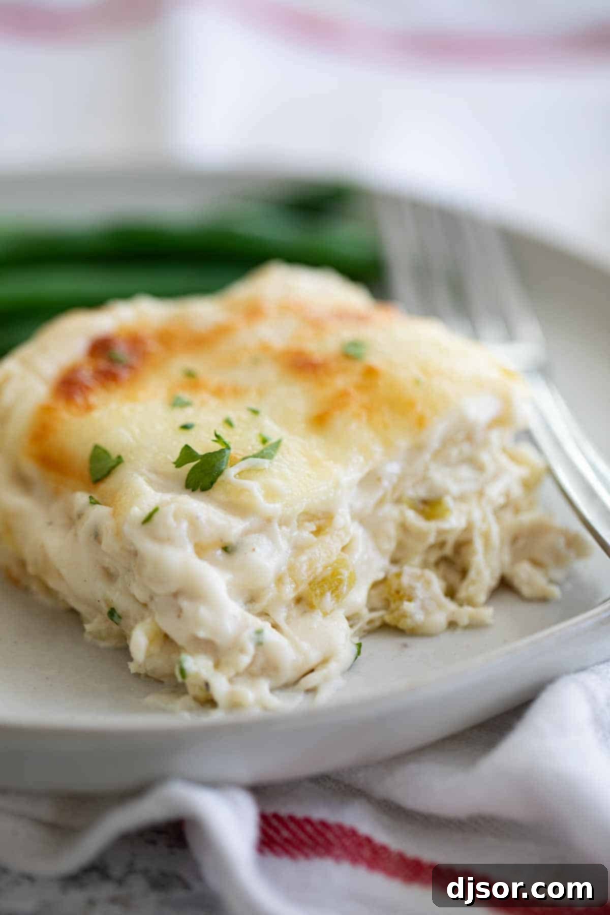 A comforting Chicken Lasagna with Green Chile and Cheese, showcasing layers of pasta, chicken, and a creamy sauce.
