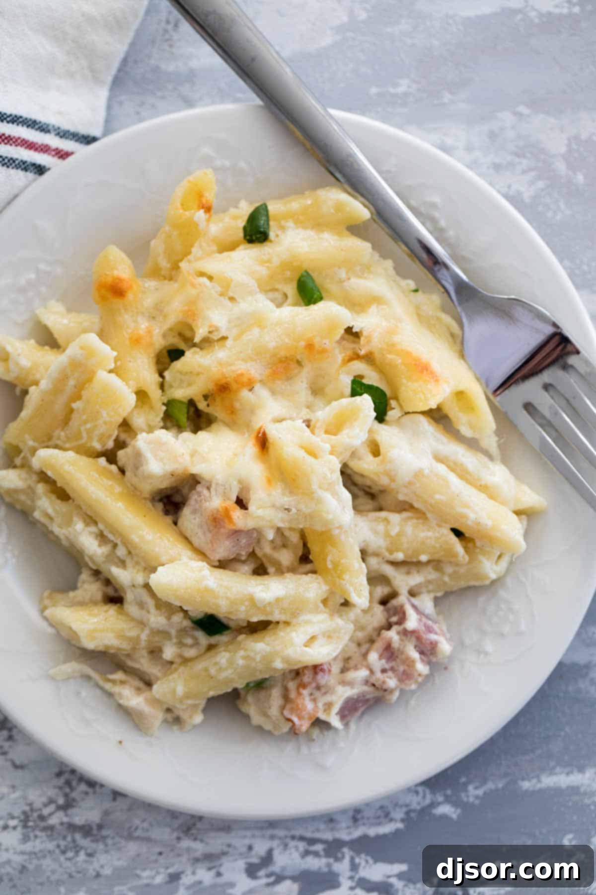 A hearty casserole dish filled with Chicken Cordon Bleu Casserole with Pasta, golden and bubbling.