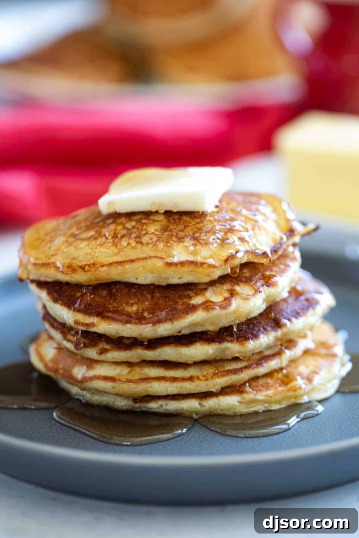 Ready-to-Serve Cornmeal Pancakes A perfectly stacked plate of golden Cornmeal Pancakes, ready to be served.