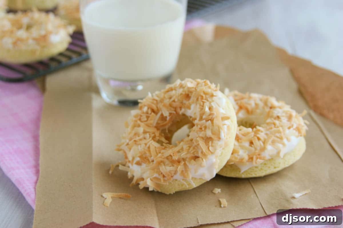 Irresistible Baked Coconut Donuts with Coconut Icing baked coconut donuts topped with coconut icing and toasted coconut, arranged beautifully on a plate