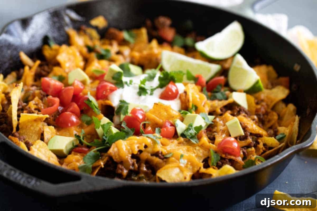 Taco Skillet served in a cast iron skillet, garnished with fresh toppings and ready to eat.