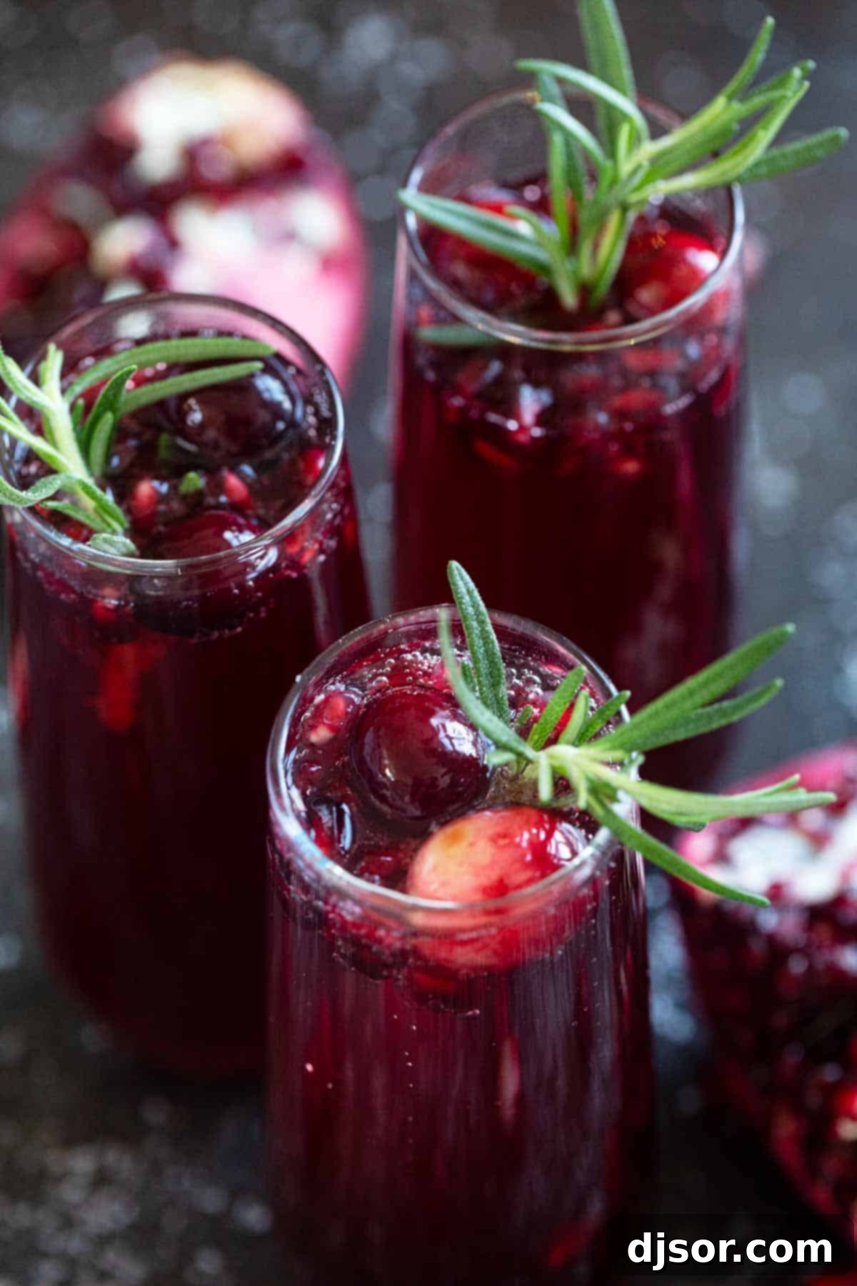 Crimson Pomegranate Cranberry Fizz 5 Virgin Pomegranate and Cranberry Bellini garnished beautifully with a sprig of rosemary and fresh cranberries.