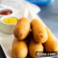 Homemade corn dog recipe served with a side of ketchup and mustard