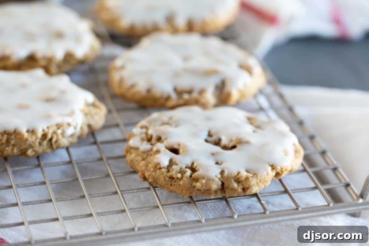 Freshly baked Iced Oatmeal Cookies cooling on a wire rack, ready for frosting.