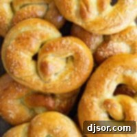 Overhead view of a stack of soft pretzels on a board