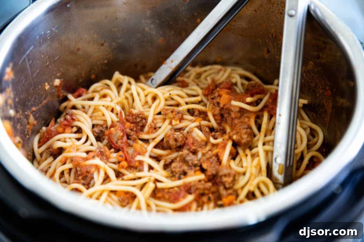 mixing spaghetti into Instant Pot Bolognese