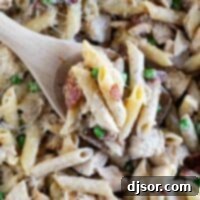 Ultimate Chicken Bacon Pasta 2 Overhead view of wooden serving spoon with Chicken Bacon Pasta.