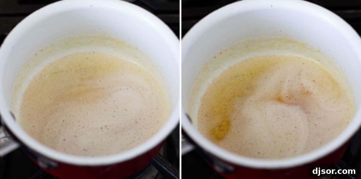 The crucial stage of browning butter to unlock its rich, nutty flavor for mashed sweet potatoes. Close-up shot of butter melting and beginning to brown in a light-colored saucepan, showing the foamy stage before achieving a deep golden hue.