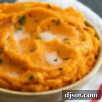 Velvety Sweet Potatoes 2 bowl of Mashed Sweet Potatoes with Brown Butter sitting on a kitchen towel