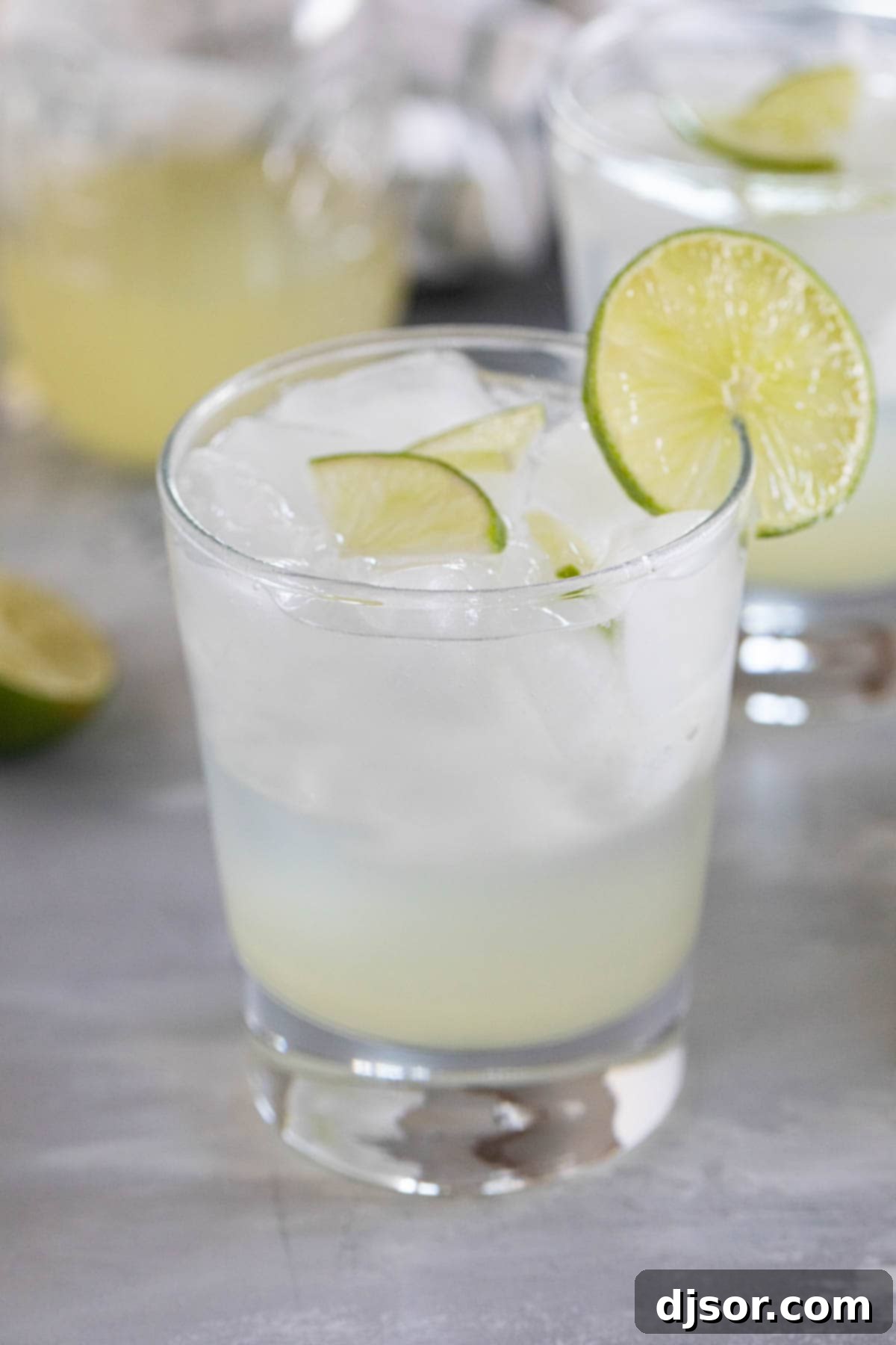 Glass of ginger limeade with a lime slice on the glass.