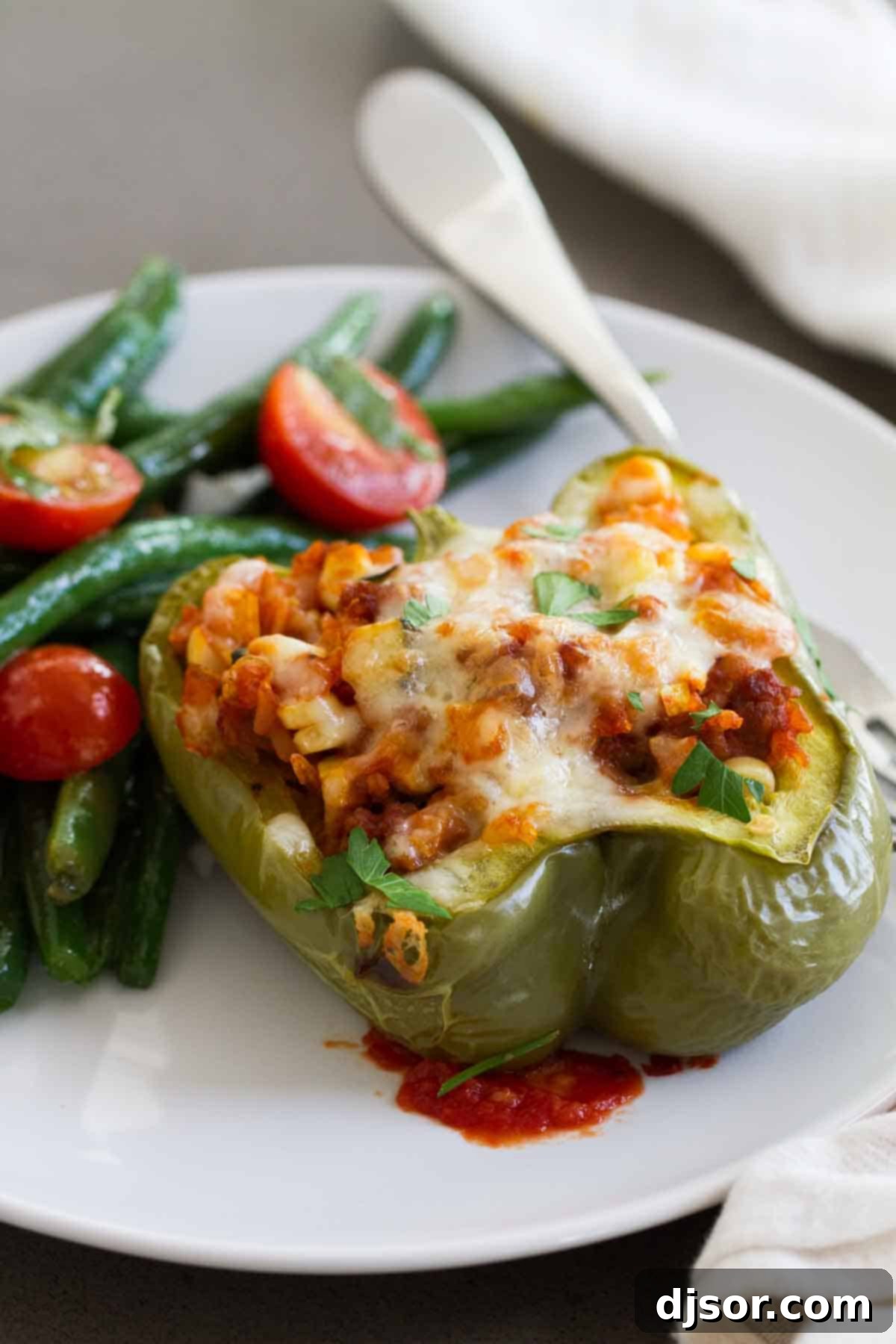 Bell pepper cut in half and stuffed with a savory mix of vegetables and sausage, a perfect summer meal