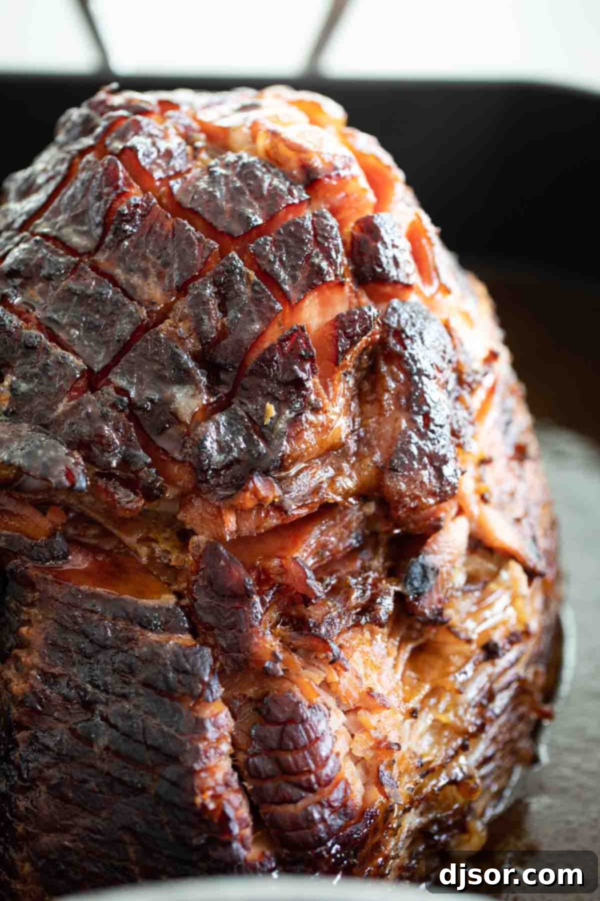 Beautifully Cooked Glazed Ham Fully cooked brown sugar glazed ham resting in a roasting dish.
