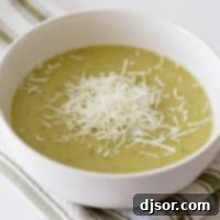 Sunshine Squash Soup 2 white bowl with zucchini soup with shredded parmesan cheese on top