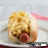 Hot dog served with homemade Mac and cheese on top.