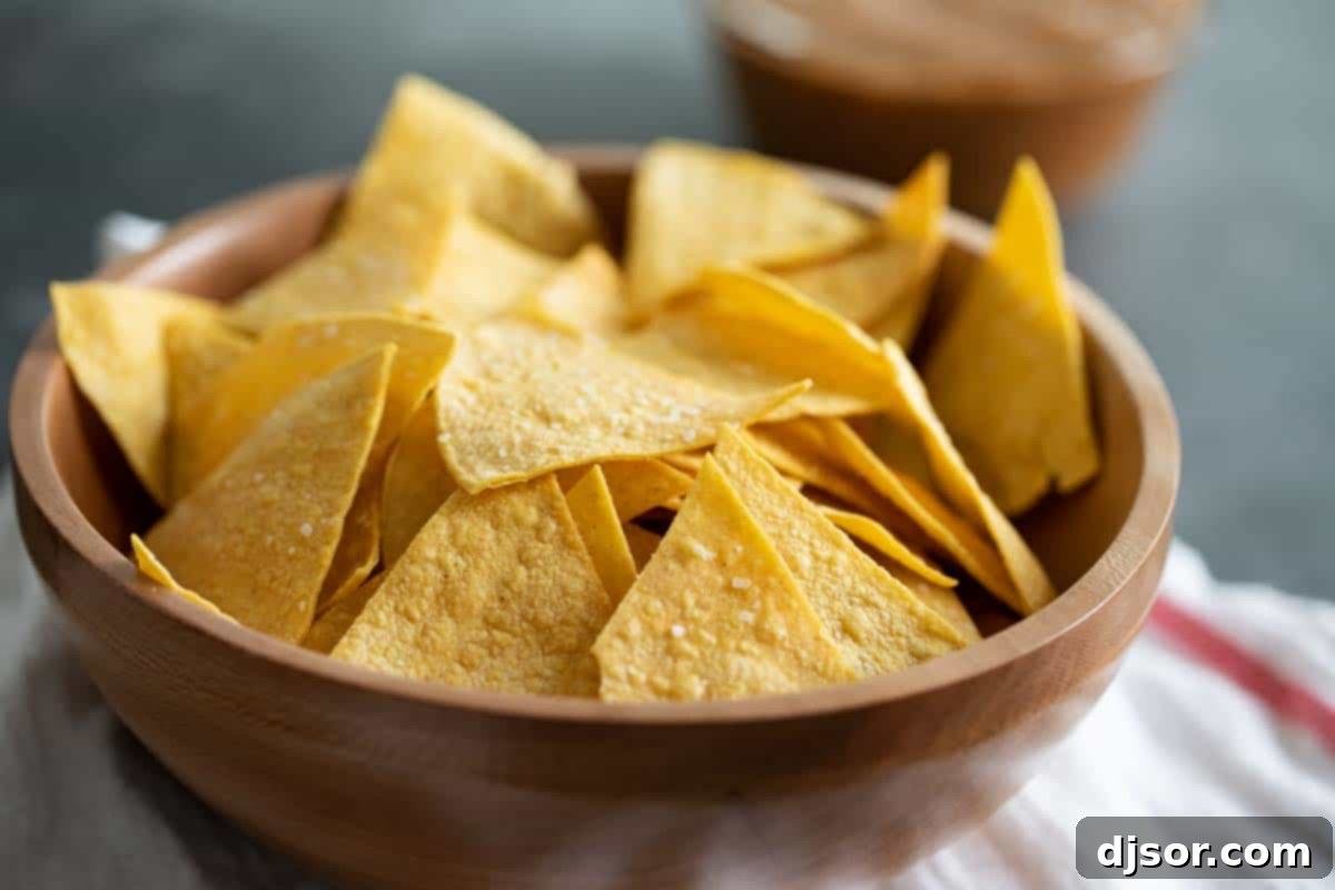Crispy Homemade Tortilla Chips A bowl overflowing with golden, crispy homemade tortilla chips, ready for dipping.