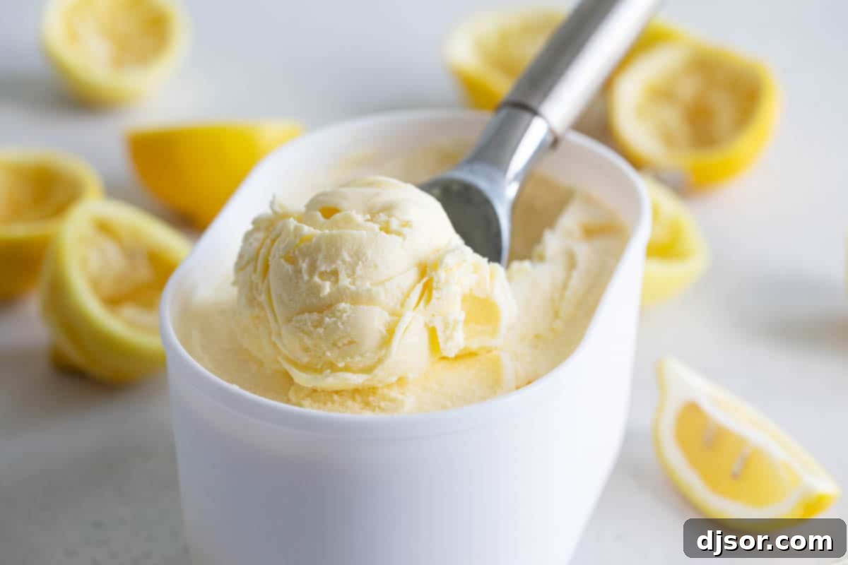 container of lemon ice cream with a scoop in the middle