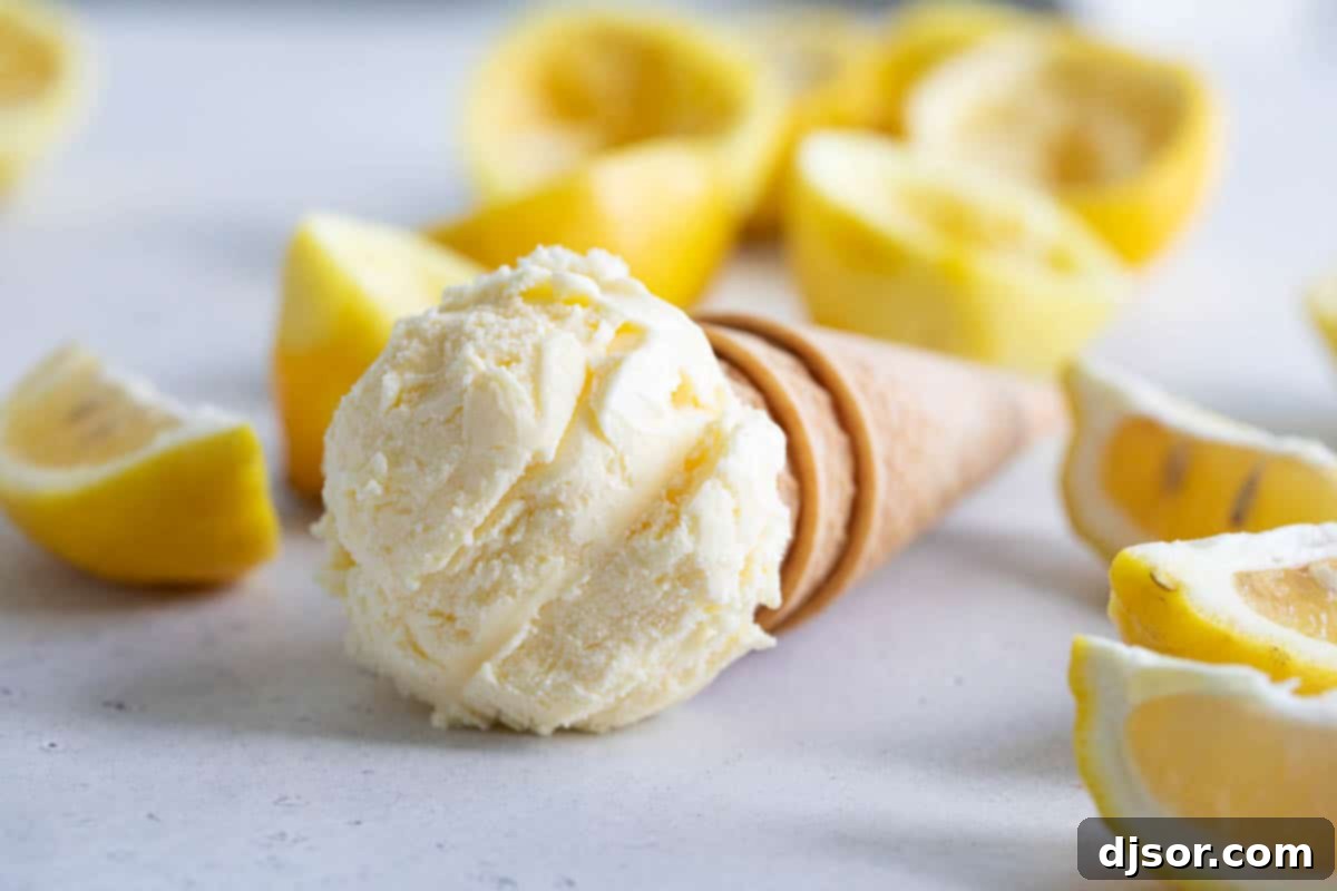 ice cream cone topped with ice cream with lemons in the background