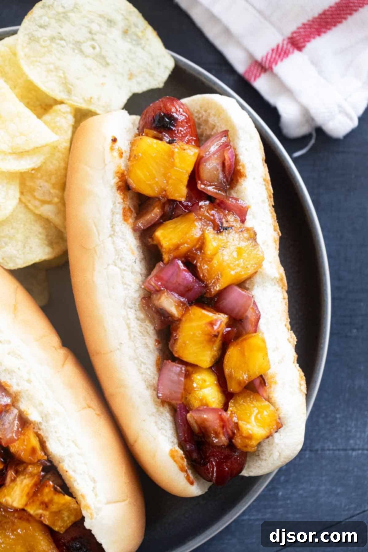 Pineapple Paradise Dogs 7 A beautifully assembled Hawaiian Hot Dog on a plate, ready to be enjoyed.