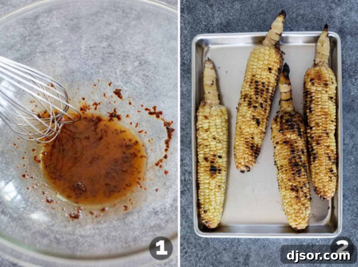 A person whisking dressing ingredients in a bowl, with ears of fresh corn placed on a baking sheet, ready for grilling.