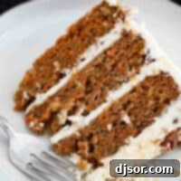 A delicious slice of traditional carrot cake on a plate, showing its moist layers and creamy frosting.